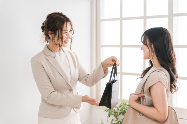 department store staff sending off a customer who has made a purchase